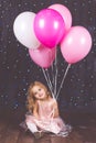 Little pretty girl in studio with pink balloons Royalty Free Stock Photo