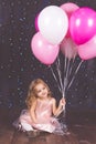 Little pretty girl in studio with pink balloons Royalty Free Stock Photo