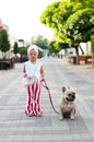 little pretty girl stylishly walking her French bulldog dog Royalty Free Stock Photo