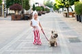 little pretty girl stylishly walking her French bulldog dog Royalty Free Stock Photo