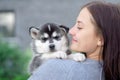 Little pretty husky puppy outdoor in womans hands Royalty Free Stock Photo