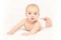 Little pretty kid. Lying at home. White background. Happy expression Royalty Free Stock Photo