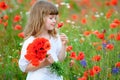 little princess child with red wild flowers. Beauty girl portrait outdoors Royalty Free Stock Photo