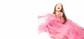 Little Princess. Portrait of a cute Caucasian little laughing girl in an evening bright pink dress on a white background. Royalty Free Stock Photo