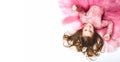 Little Princess. Portrait of a cute Caucasian little laughing girl in an evening bright pink dress lies on a white background. Royalty Free Stock Photo