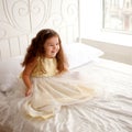 Little princess on a white bed. Royalty Free Stock Photo