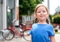 Little proud girl, child standing looking at the camera with chin up, holding head up high, smug face, back straight. Sassy, proud Royalty Free Stock Photo