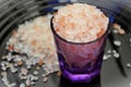 Little purple cup with pink Himalayan salt under the plate Royalty Free Stock Photo