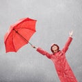 A little rain wont dampen my mood. A beautiful young woman standing outside with her red umbrella. Royalty Free Stock Photo