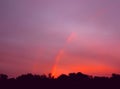 Little Rainbow, sunrise sunset times. Multicolour rainbow on the pink sky