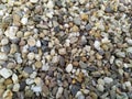 Little raw rocks and gravel minerals as natural stones background with crushed and rough material at a rough coast or rocky beach Royalty Free Stock Photo