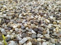 Little raw rocks and gravel minerals as natural stones background with crushed and rough material at a rough coast or rocky beach Royalty Free Stock Photo