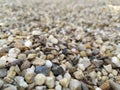 Little raw rocks and gravel minerals as natural stones background with crushed and rough material at a rough coast or rocky beach Royalty Free Stock Photo