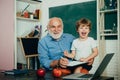 Little ready to study - generation people concept. Teacher is skilled leader. Happy cute Grandson and Grandfather Royalty Free Stock Photo