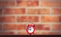 Little red alarm clock on table Royalty Free Stock Photo