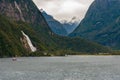 A Small Red Boat navigating Milford Sound Royalty Free Stock Photo