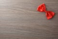 Little red bow for event background decoration on wooden table