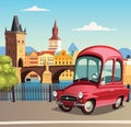 Little red car in Prague and the Charles Bridge in background