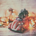 Little red car toy carrying Christmas tree in snow and bokeh christmas lights Royalty Free Stock Photo