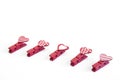 Little red clothespins hearts. On white background. Love Royalty Free Stock Photo