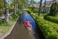 Little red electric motorboat in the central canal of Giethoorn