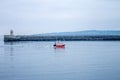 Little red fishing boat entering the river Tyne