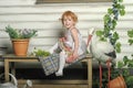 Little red-haired girl in a white dress with a bouquet of flowers Royalty Free Stock Photo