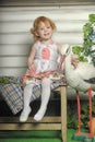 Little red-haired girl in a white dress with a bouquet of flowers Royalty Free Stock Photo