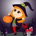 A little red-haired witch cheerfully runs with a basket of pumpkins for sweets against the backdrop of bushes.