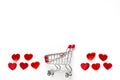 The little red hearts around of shopping cart on the white background.Valentines Day flat lay with place for text Royalty Free Stock Photo