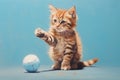 Little red kitten plays with a blue ball. Illustration aquarelle of a playful cat on blue background. AI Generated Royalty Free Stock Photo