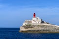 Little red old lighthouse on a rock near Bonifacio Corsica