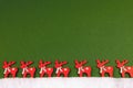 Little red reindeers on green ground - decoration for Christmas time Royalty Free Stock Photo