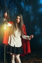 Little Red riding hood in the dark forest with a lantern Royalty Free Stock Photo