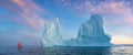 Little red sailboat cruising among floating icebergs in Disko Bay glacier during midnight sun season of polar summer. Greenland