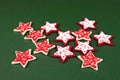 Little red stars on green ground - decoration for Christmas time Royalty Free Stock Photo