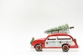 Little red vintage car carrying a Christmas tree on top Royalty Free Stock Photo