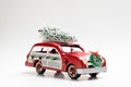 Little red vintage car carrying a Christmas tree on top Royalty Free Stock Photo