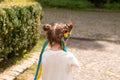 Little redhead preschooler girl with pigtails in national ukrainian folk decoration wreath outdoors