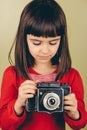 Little retro photographer with an old camera