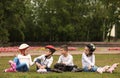 Little roller skaters sitting on grass