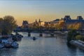 Little Romantic Boat on Seine River in Paris at Autumn Sunset With Tourists on Bridge