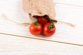 Little sack and red ripe tasty fresh cherry tomatos Royalty Free Stock Photo