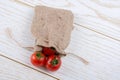 Little sack and red ripe tasty fresh cherry tomatos Royalty Free Stock Photo