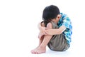 Little sad boy barefeet sitting on floor. Isolated on white back