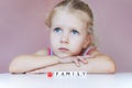 Little sad girl dream about family. Protect your family concept. Royalty Free Stock Photo