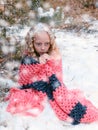 Little sad girl frozen in the winter forest
