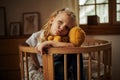 A Little Girl Sitting On The Bed In A Hug With Her Teddy Bear. Child, Home. Royalty Free Stock Photo