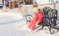 Little sad girl sitting on a bench in the skating Royalty Free Stock Photo