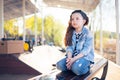 Little sad girl sitting lonely on a bench Royalty Free Stock Photo